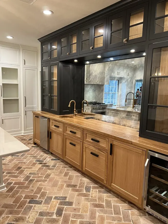 Oak and black wet bar with brick herringbone floor