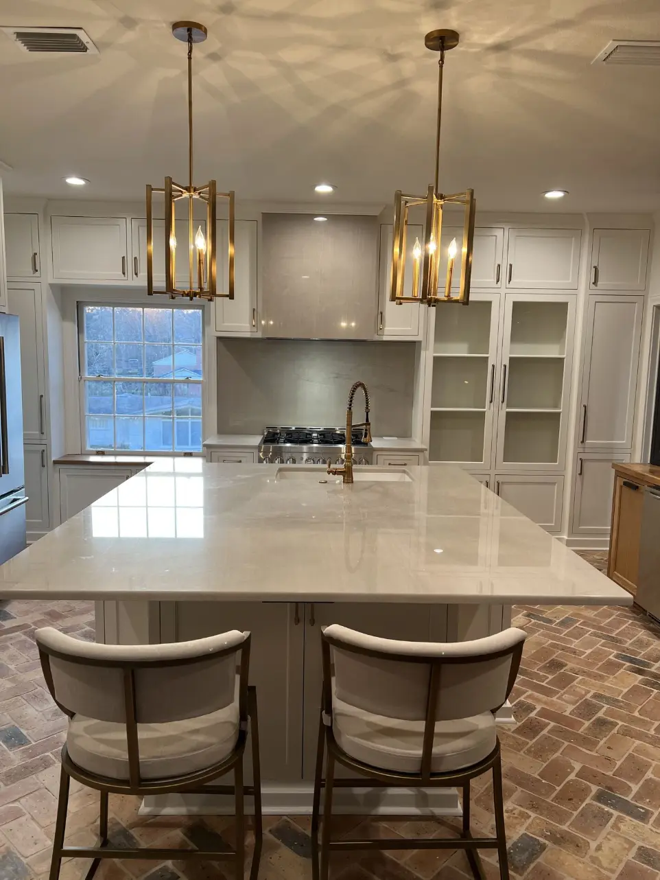 Cream kitchen with brass lantern pendants